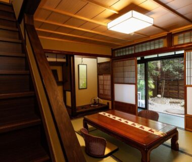 Tatami room with low wooden table, zabuton and shoji doors opening to small courtyard at Kyomachiya Bettei Hanatei Kyoto