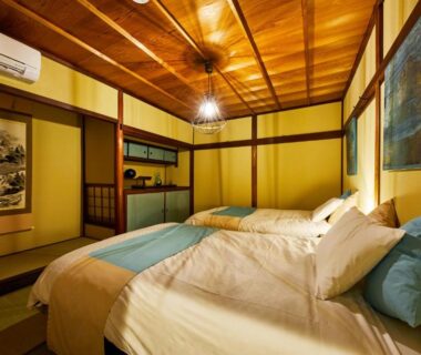 Tatami room with two beds, wooden ceiling, shoji screens and tokonoma at Kyomachiya Hotel Mifuku, Kyoto