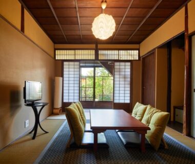 Tatami sitting room with low table and shoji screens at Kyomachiya Hotel Mifuku in Kyoto, Kansai