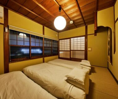 Tatami room with futons and shoji screens at Kyomachiya Hotel Mifuku Kyoto
