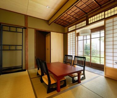Tatami room with low table, chairs and shoji screens overlooking garden at Kyomachiya Hotel Mifuku, Kyoto