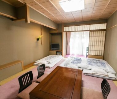 Traditional tatami room with low table and futons at Kyonoyado Kagihei in Kyoto Kansai