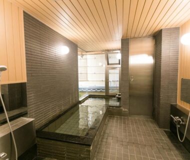 Wood-lined indoor soaking pool with shower stations at Kyonoyado Kagihei, Kyoto, Kansai, Japan