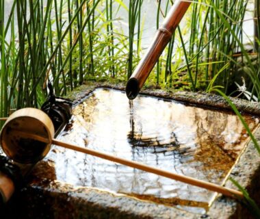 Stone tsukubai with bamboo spout and ladle at Kyoto Arashiyama Onsen Ryokan Togetsutei