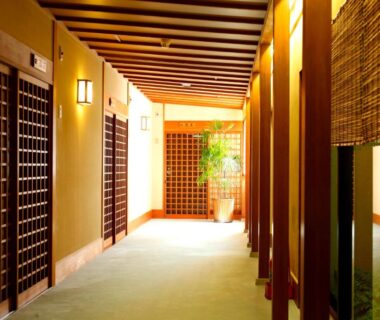 Wooden hallway with shoji and lattice doors at Kyoto Arashiyama Onsen Ryokan Togetsutei