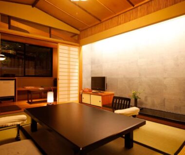 Tatami room with low table, shoji screens, zabuton cushions at Kyoto Arashiyama Onsen Ryokan Togetsutei