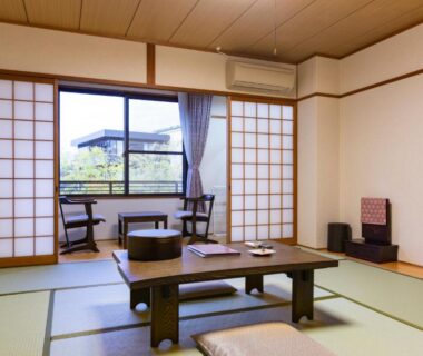 Tatami room with low table, shoji screens and window seating at Kyoto Higashiyamaso, Kyoto