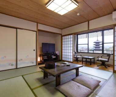Traditional tatami room with low table, shoji screens and pagoda visible through window at Kyoto Higashiyamaso