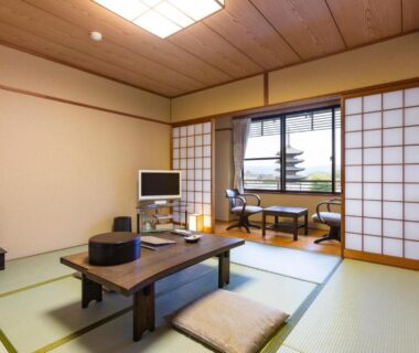 Tatami room with low wooden table, floor cushions and shoji screens at Kyoto Higashiyamaso, Kyoto
