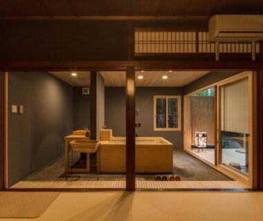 Tatami room with shoji screens, low wooden table and seating area at Kyoto Nanzenji Ryokan Yachiyo