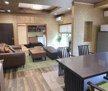 Open living area with sofas, dining table and kitchenette at Kyoto Ryokan Gion Sano, Kyoto
