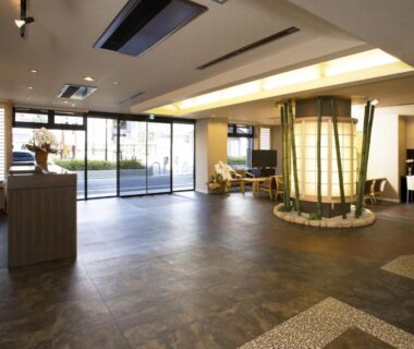 Spacious ryokan lobby featuring central lantern, seating area and glass doors at Kyoto Ryokan Hirashin in Kyoto