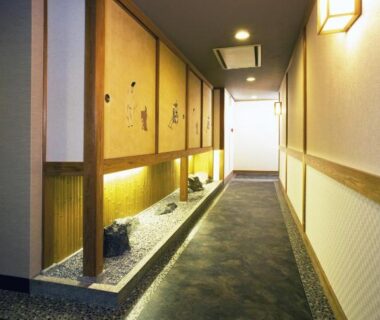 Lit corridor with decorative sliding panels at Kyoto Ryokan Hirashin, Kyoto, Japan