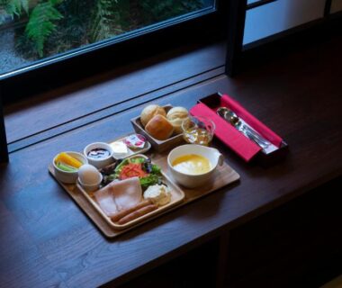 Japanese breakfast tray on wooden windowsill with shoji screens and garden outside at Kyoto Takasegawa Bettei Kyoto