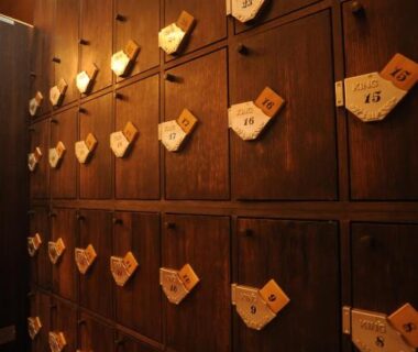Wooden cubby lockers with hanging key tags at Kyoto Takasegawa Bettei, Kyoto, Kansai, Japan