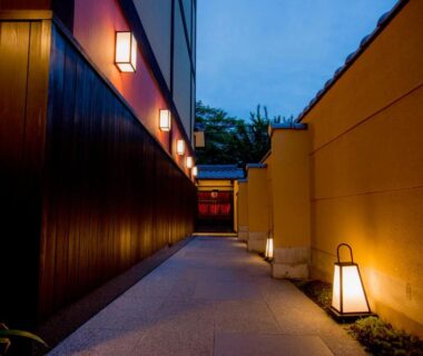 Evening lantern-lined walkway leading to the entrance of Kyoto Takasegawa Bettei in Kansai