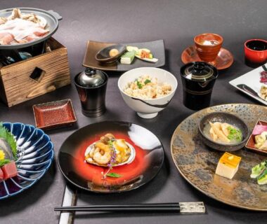 Assorted Japanese dishes on low table at Kyoto no Yado Gion no Tsuki ryokan Kyoto