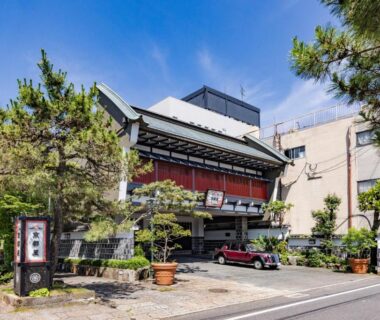 Exterior of Kyotoya ryokan with traditional facade, potted plants and street frontage in Saga, Kyushu