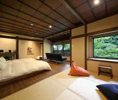 Spacious tatami room with futon, shoji screens and garden view at Kyousen in Nagano, Chūbu Japan