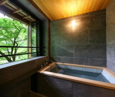 Indoor stone bath with wooden tub by open window, Kyousen ryokan, Nagano Chubu region