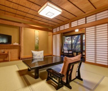 Tatami room with low table and zaisu chairs at Kyousen, Nagano