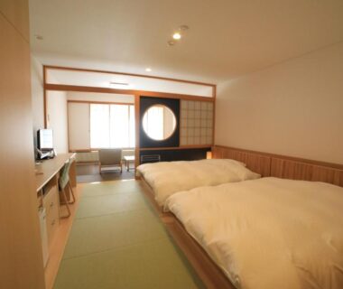 Tatami floor room with two beds, shoji screens and round window, Kyukamura Nikko-Yumoto, Tochigi