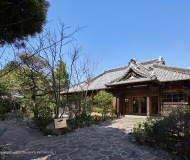 Stone path leading to traditional wooden ryokan entrance with tiled roof and garden, LOQUAT西伊豆, Shizuoka