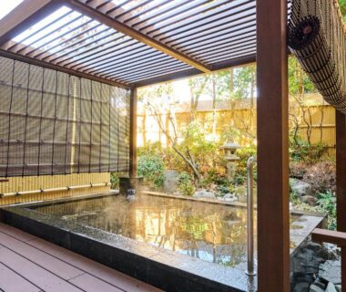 Wooden deck outdoor bath with pergola and bamboo screens beside small garden at Laforet Hakone Gora, Kanagawa