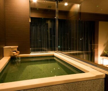 Indoor wooden soaking tub at Laforet Ito Onsen Yunoniwa in Shizuoka, Chūbu Japan with warm lighting