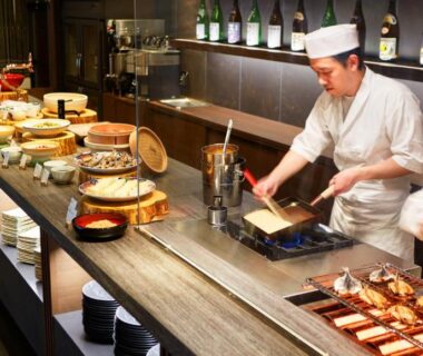 Chefs preparing dishes behind a counter at Laforet Ito Onsen Yunoniwa in Shizuoka, Chūbu, Japan