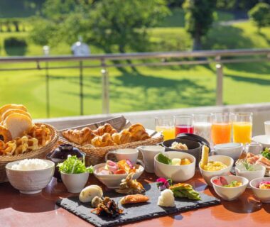 Assorted Japanese and Western breakfast dishes on a table with garden view at Laforet Shuzenji Sanshisuimei Shizuoka