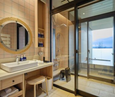 Bathroom vanity, glass-enclosed shower and soaking tub at Lake Toya Tsuruga Resort HIKARINOUTA in Hokkaidō