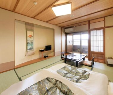 Tatami room with futons and low table at Lakeland Hotel Mizunosato in Yamanashi, Chūbu
