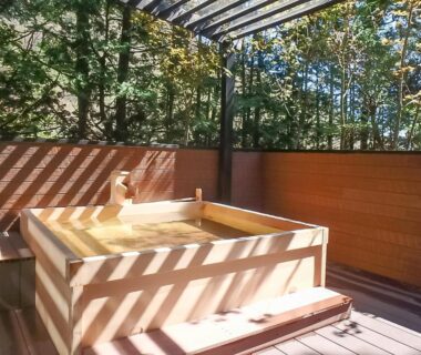 Outdoor wooden soaking tub on timber deck with slatted pergola at LiVEMAX RESORT Hakone Ashinoko, Kanagawa