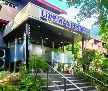 Glass front resort entrance with staircase and surrounding greenery at LiVEMAX RESORT Hakone Ashinoko Kanagawa