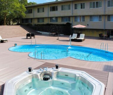 Outdoor swimming pool and spa tub on wooden deck at LiVEMAX RESORT Kaga Yamashiro, Ishikawa, Chūbu Japan