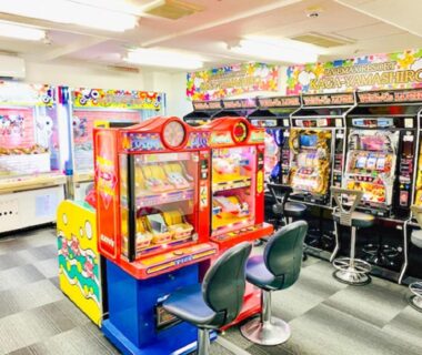 Indoor arcade room with claw and slot machines and seating at LiVEMAX RESORT Kaga Yamashiro in Ishikawa