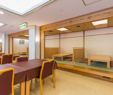 Mixed seating dining area with tatami platforms, low wooden tables and western chairs at LiVEMAX RESORT Kaga Yamashiro, Ishikawa