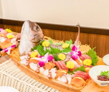 Wooden sashimi boat with whole fish and garnishes at LiVEMAX RESORT Kusatsu Onsen in Gunma, Kantō