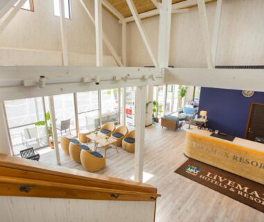 High-ceiling reception with seating, wooden beams and floor-to-ceiling windows at LiVEMAX RESORT Kyotango, Kansai, Japan
