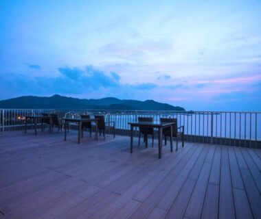 Outdoor deck seating overlooking coastline at LiVEMAX RESORT Kyotango Sea Front in Kyoto