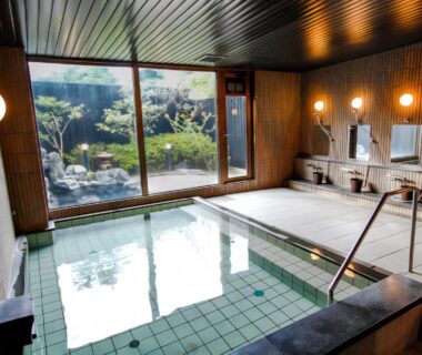 Indoor tiled onsen bath overlooking a small garden at LiVEMAX RESORT Kyotango Sea Front, Kyoto Kansai