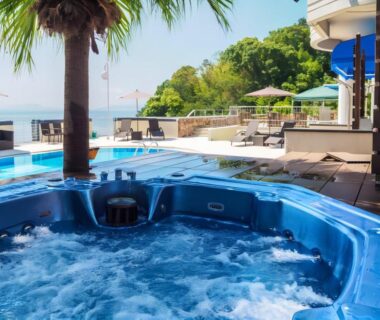 Bubbling outdoor hot tub with pool deck, lounge chairs and sea view at LiVEMAX RESORT Setouchi Hyōgo