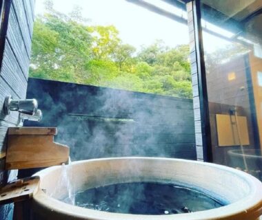 Steaming wooden soaking tub with garden view at LiVEMAX RESORT Shizuoka Amagiyugashima, Chūbu, Japan