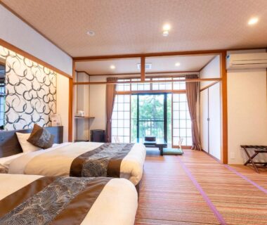 Japanese-style room with tatami flooring, two beds, shoji sliding doors and balcony at Livemax Resort Yuhigaura Kitu Onsen Kyoto