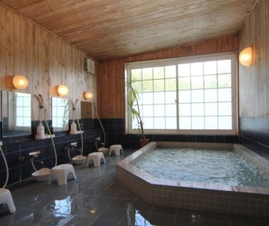 Tiled bathing area with stools, washing stations and shoji window at Lodge Clubman Iwate