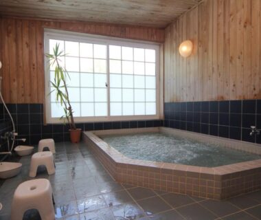 Indoor tiled soaking bath with shower stools and shoji window at Lodge Clubman, Iwate, Tōhoku Japan