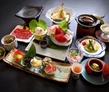 Assorted small dishes and sashimi on lacquerware for a ryokan dinner at Manseiro in Wakayama, Kansai