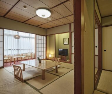 Tatami room with low table, shoji screens and seating area at Manseiro, Wakayama, Kansai