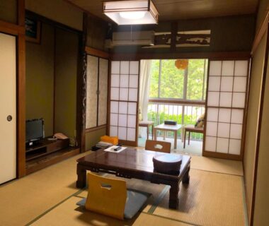 Tatami room with low table and shoji screens at Manten-no-Hoshi in Kanagawa Japan